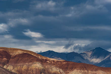 Rocks under blue sky. Sunny day in mountain valley. Colorful hills, Hiking in summerの写真素材