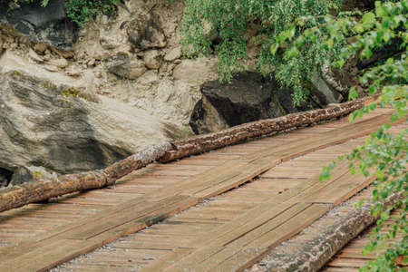 Bridge of logs and sleepers. Wooden flooring for transportation. Ecological road without asphaltの写真素材