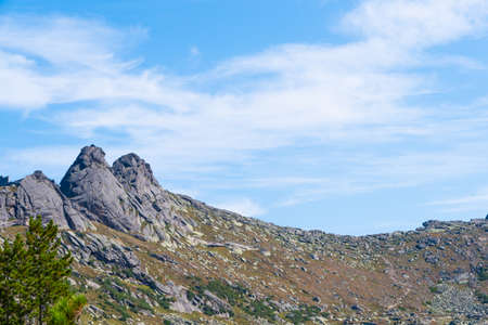 rock ridge under blue cloudy sky, mountain tourism, tourist area for relaxationの写真素材