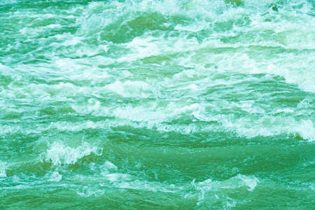 rough ocean waves, stormy sea surf, fast flowing mountain riverの写真素材