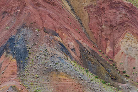 Colored hills, stripes of different colors on slope of canyon. Dry land due to lack of water. Drought in desert. Soil erosionの写真素材