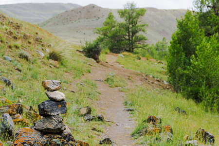 Slide of stones for orientation in forest. Hiking in mountains. Meditation, state of balance of  soul. Yoga classes in natureの写真素材