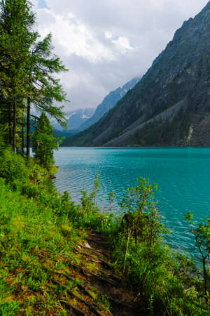 Turquoise lake among rocks. Mountain pond for hikingの写真素材