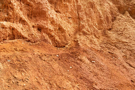 Red mountainside on hot day. Texture on wall of sandy canyon. Lack of water, drought from climate changeの写真素材