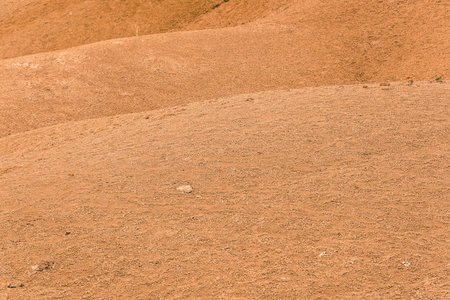 Red mountainside on hot day. Texture on wall of sandy canyon. Lack of water, drought from climate...