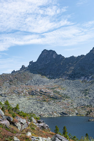 rock ridge under blue cloudy sky, mountain tourism, tourist area for relaxation