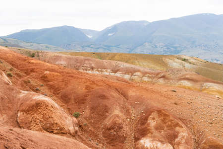 canyon with red sandy slopes. Desert hills with soil erosion, formation of ravines due to droughtの写真素材