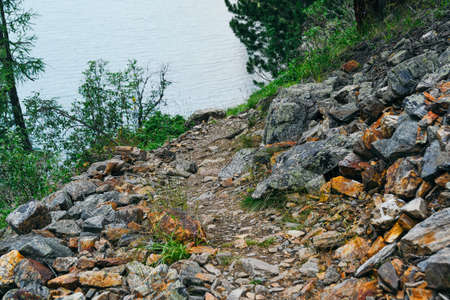 Gray old boulders on hillside. Danger of stone mudslide in the highlands.の写真素材
