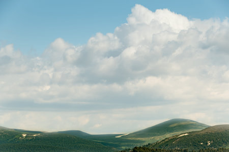 Cumulus over strip of hills on horizon. Upward air flows from heating, formation of atmospheric...