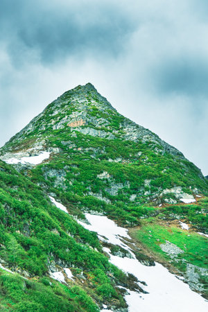 Alpine range on horizon. Structure of rocks with stones on slope. Silhouette mountain line. Plan to...