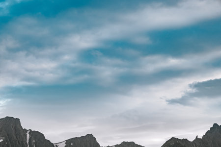 Ridge of hills on thick rain clouds. Travel to mountain valley on foot. Admiration for atmosphere,...