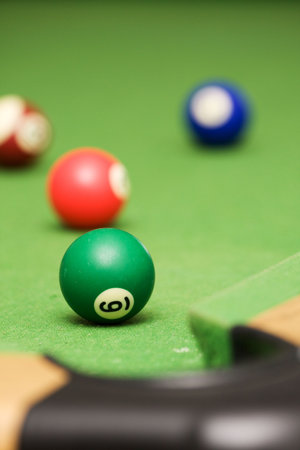 Four pool balls on a green filt covered pool table