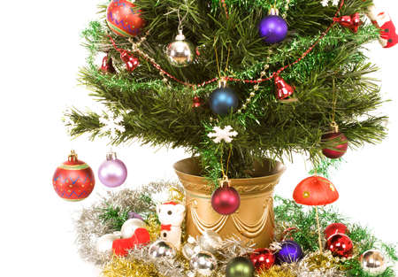 Artificial Christmas tree draped with traditional decorations. Isolated on white backgroundの写真素材