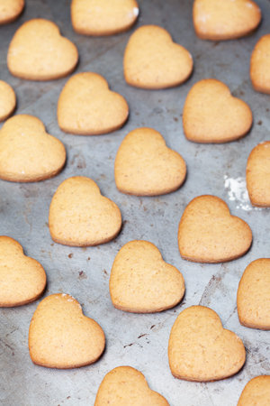 Home made heart shaped cookies on metal baking tray