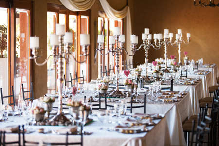 Hall at a wedding reception with decorated tablesの写真素材