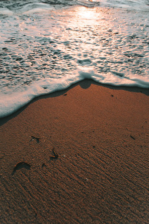 Half tide and foam and half sand