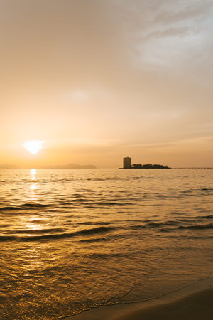 Minimalistic shot of a building silhouette over the sea