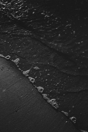 Black and water close up of a single tideの写真素材