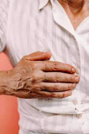 An old woman resting palm on chestの写真素材