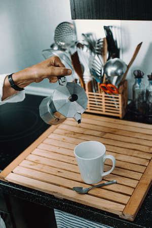 Senior woman about to serve some coffeeの写真素材