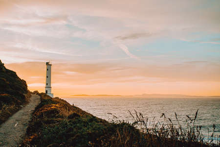 Horizontal shot of the white lighthouse during the sunsetの写真素材