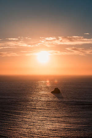 Massive sunset over the horizon on the coastの写真素材