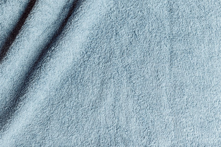 A top view from the top of a light blue towel with two wrinkles