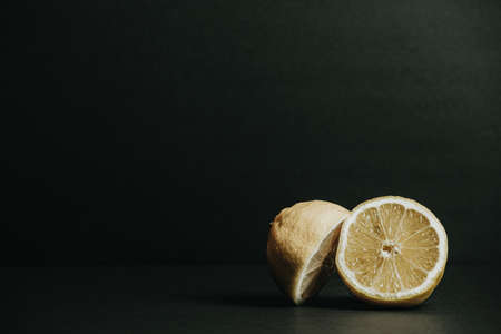 Two halves of a lemon over a dark backgroundの写真素材