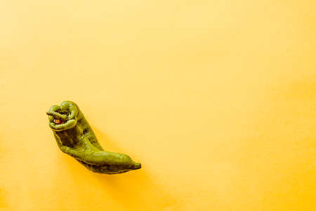 Top view of a pepper over a yellow backgroundの写真素材