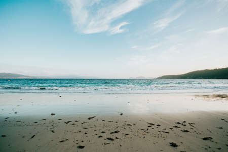 A clean and minimalistic shot of a beach during a bright and sunny day of summerの写真素材