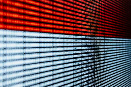 An horizontal red and white binary language over a screen backgroundの写真素材