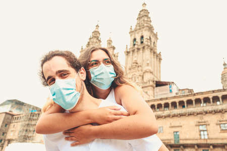 A young couple having a good time while traveling having the masks put onの写真素材
