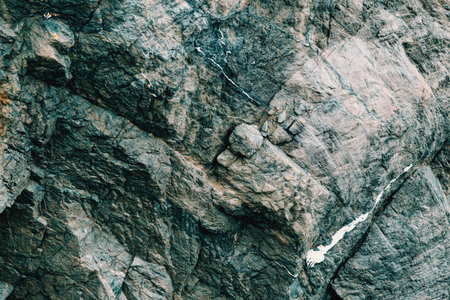 A flat background of a gray rock with bluish tones over it