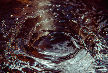 Some breaking time stopped water background in black, red and magenta tones with the light...