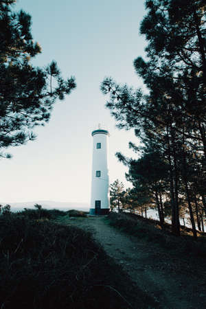 A beautiful blue and white lighthouse in the coastline of Spainの写真素材