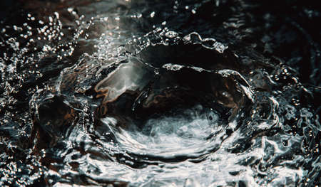 Some water exploding time stopped in black and white reflectionsの写真素材