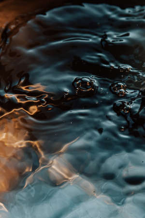 A relaxing background of time stopped water in dark tonesの写真素材