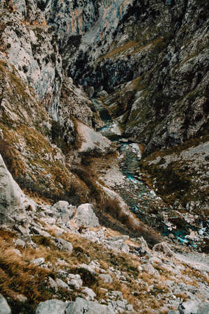 A close up of the river going through the mountains during an autumnal dayの写真素材