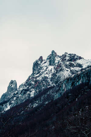 A super close up of the peak of a rocky mountain after a hard snowingの写真素材