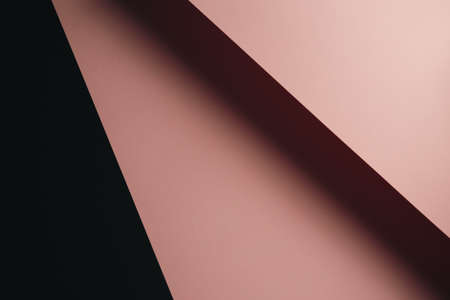 A pastel pink and black flat lay background with sharp layers and shadows with copy spaceの写真素材