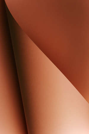 A vertical skin toned flat lay background with sharp layers and shadows with copy spaceの写真素材