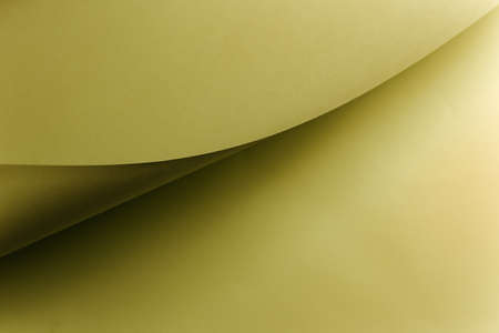 An olive color flat lay background with sharp layers and shadows with copy spaceの写真素材