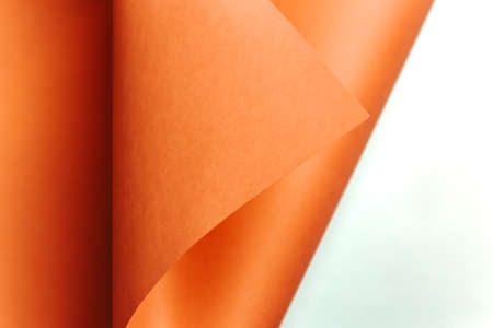 A orange and white flat lay background with sharp layers, curves and shadows with copy spaceの写真素材