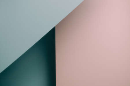 A pink and blue blue pastel flat lay background with sharp layers and shadows with copy space genderの写真素材