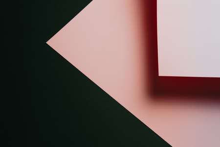 A pink and black flat lay background with sharp layers and shadows with copy spaceの写真素材