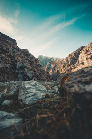The ant view of the tallest peak of the mountain range with another mountains around and a gloomy ambient in Asturiasの写真素材