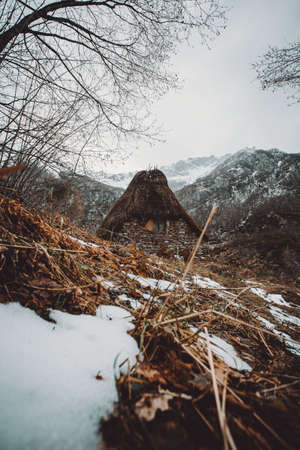 A cabin in the middle of the snowy mountains during winter in Asturias with a rural view and trekking refugeの写真素材