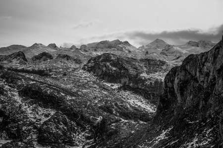 A close up of the mountain range during winter with snow and copy space in black and whiteの写真素材