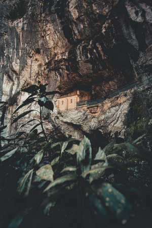 A colorful shot a church in the middle of a cave in asturias, covadonga during a sunny dayの写真素材