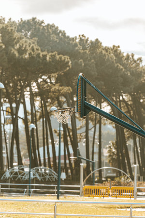 A basketball net with a sunlight sunset as the background during a spring dayの写真素材